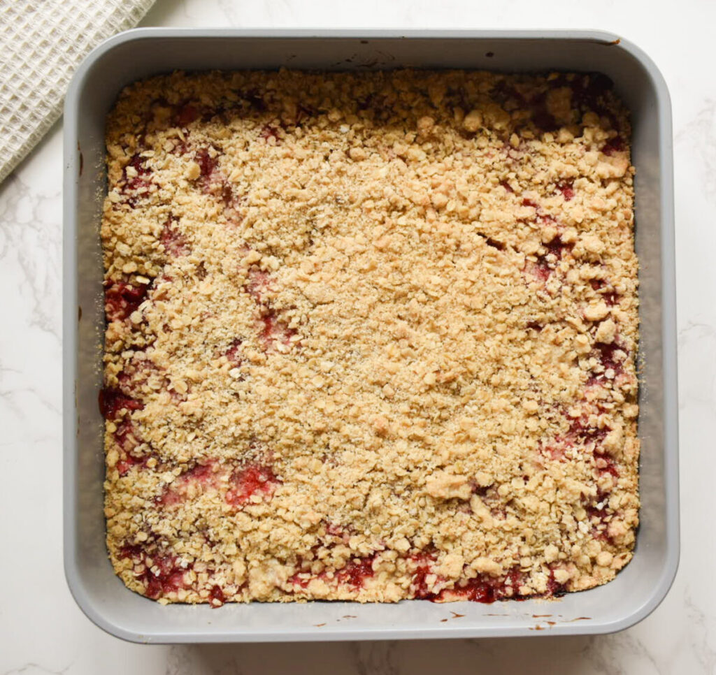 strawberry bars with crumble topping ready to be baked