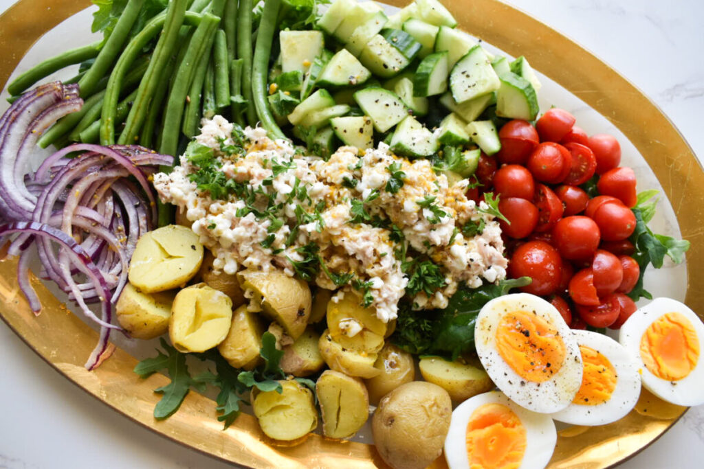 tuna and cottage cheese salad with veggies, eggs, and potatoes