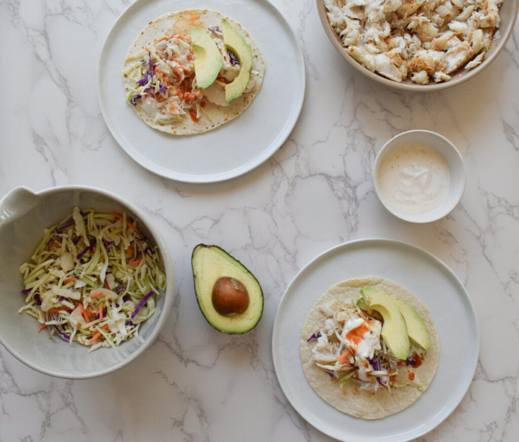 assembled fish tacos with cabbage slaw