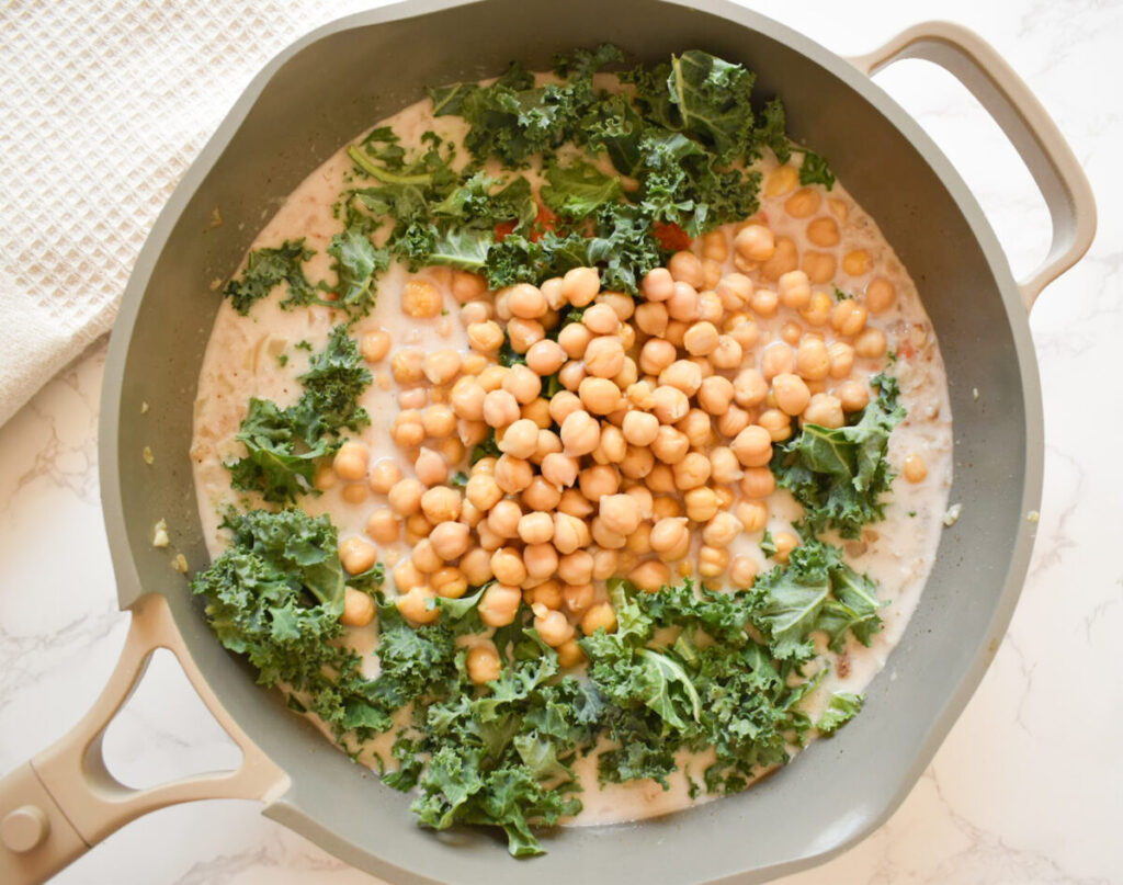 chickpea, kale, coconut milk, and aromatics ready to simmer for coconut curry
