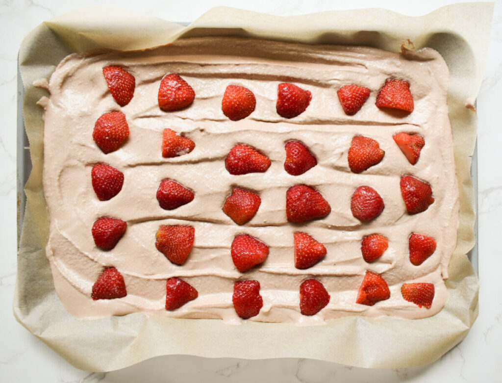 banana bark topped with strawberries ready to go in the freezer