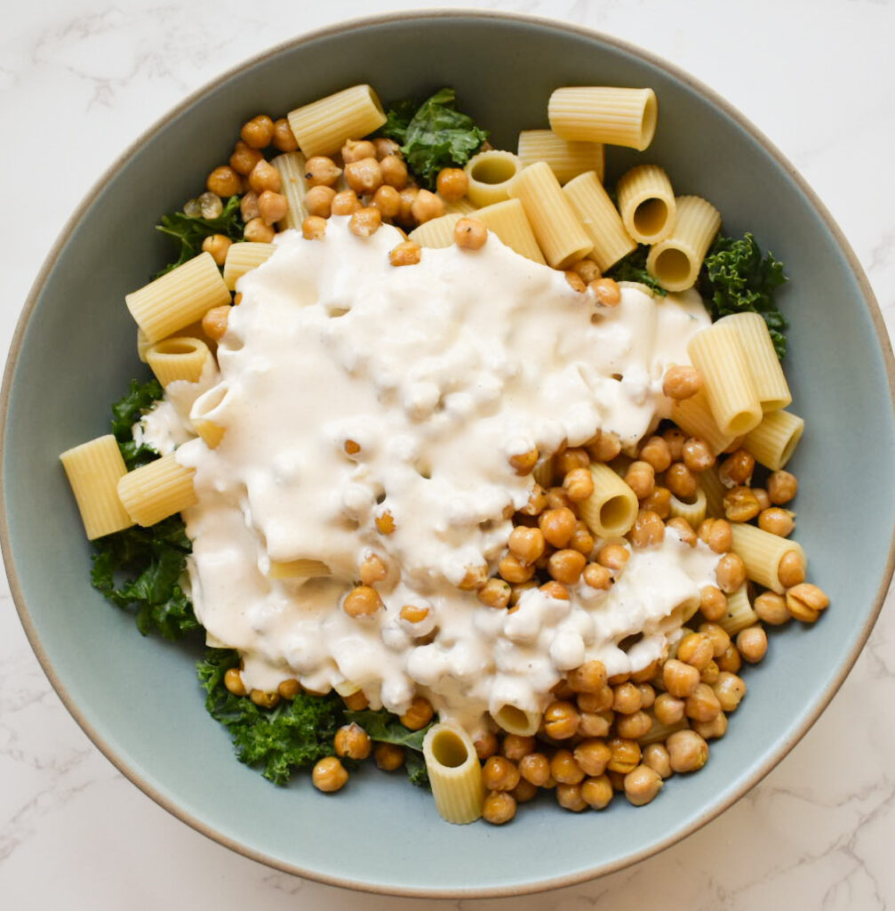 combined ingredients for kale caesar salad, ready to be tossed