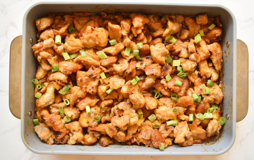 baked firecracker chicken topped with green onion