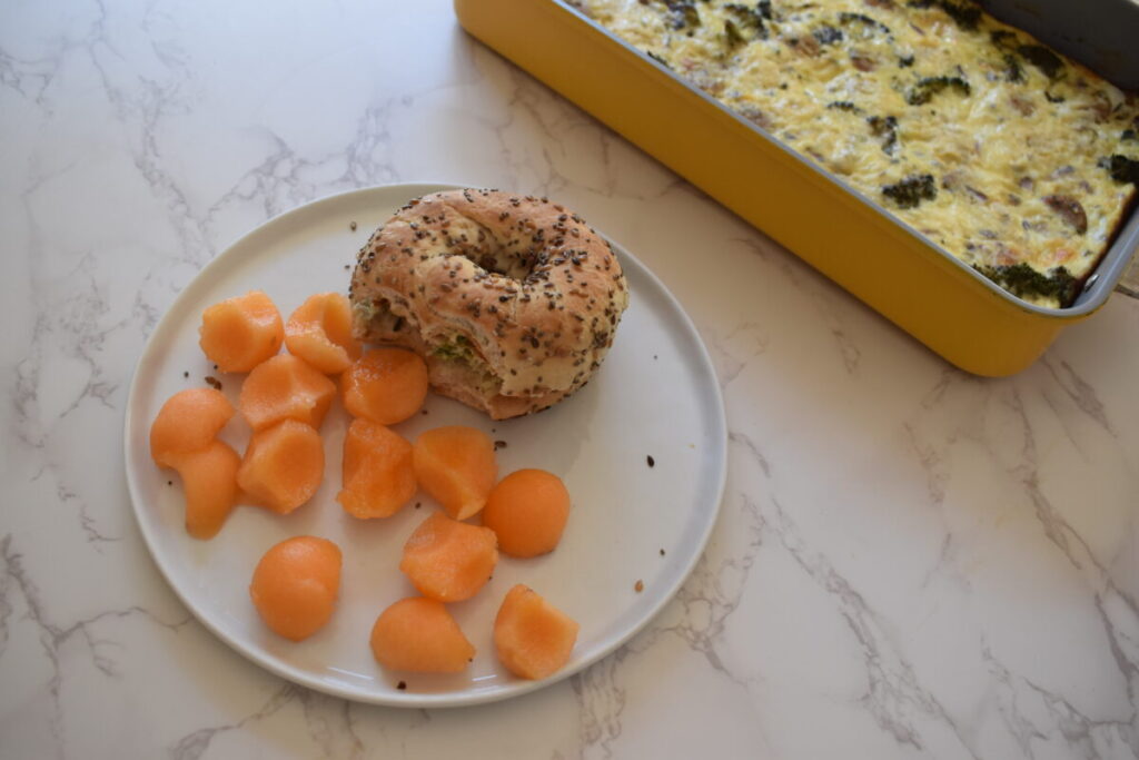 egg casserole served on a bagel with fruit