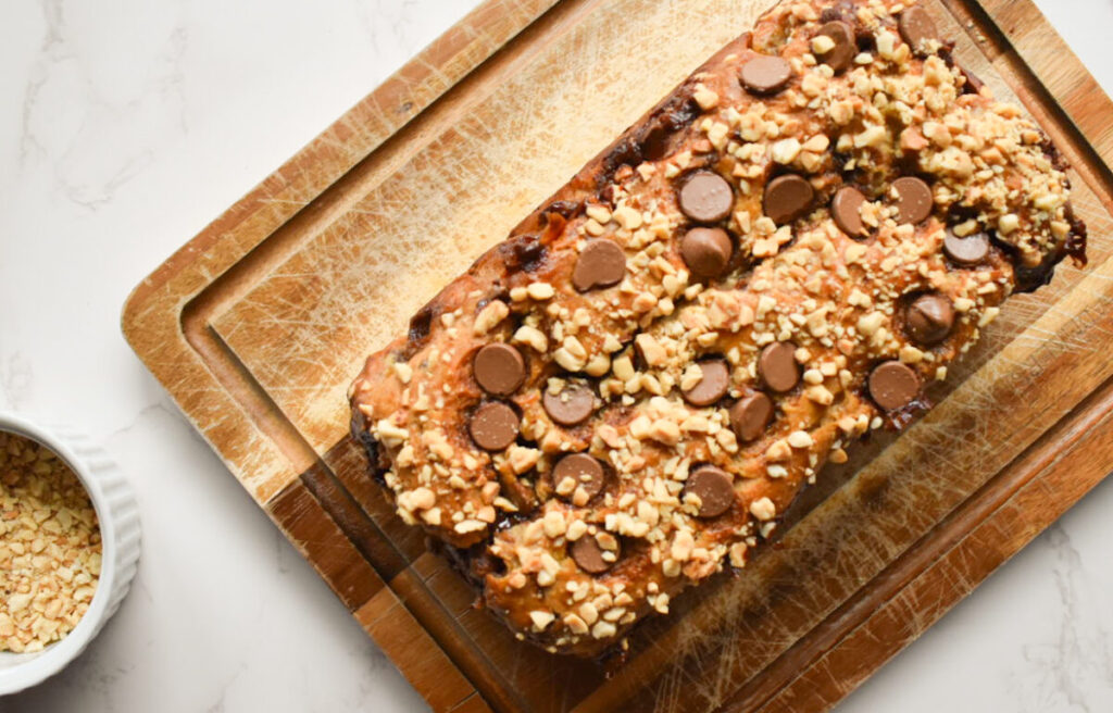 peanut butter banana bread topped with chopped peanuts