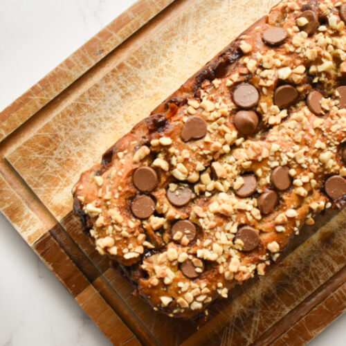 peanut butter banana bread topped with chopped peanuts