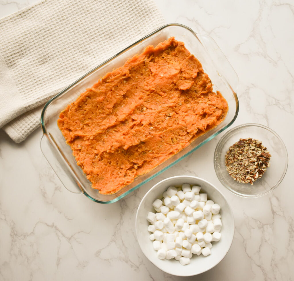Fork mashing sweet potato with butter and cinnamon