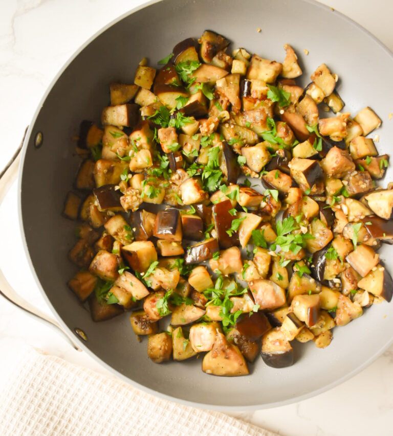 Garlic sautéed eggplant cooking in a skillet