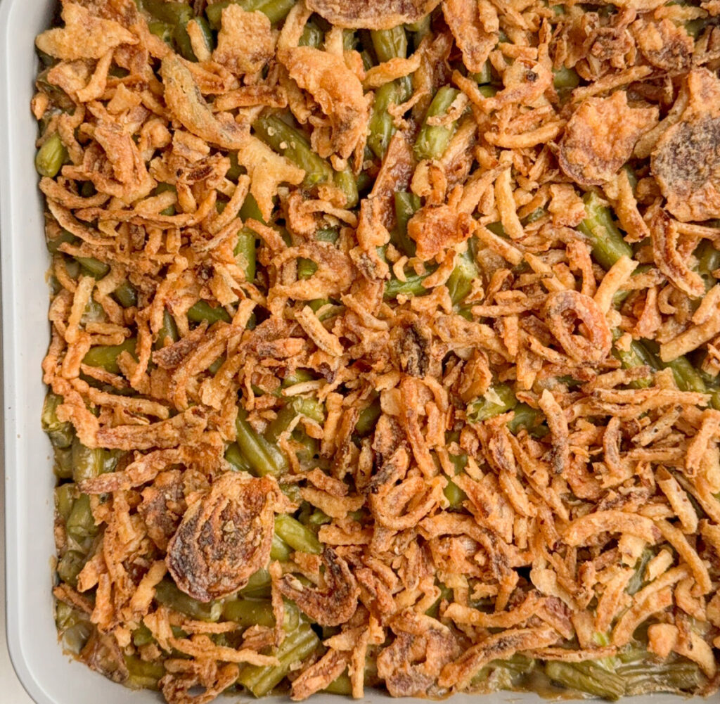 freshly baked creamy green bean casserole with crispy onions