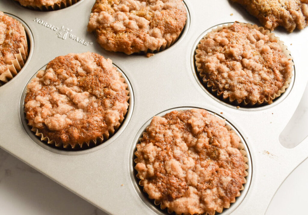 Cinnamon crumble banana muffins on in muffin tin