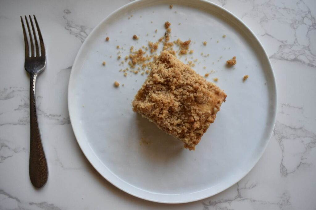 Applesauce cinnamon crumb coffee cake sliced in baking pan