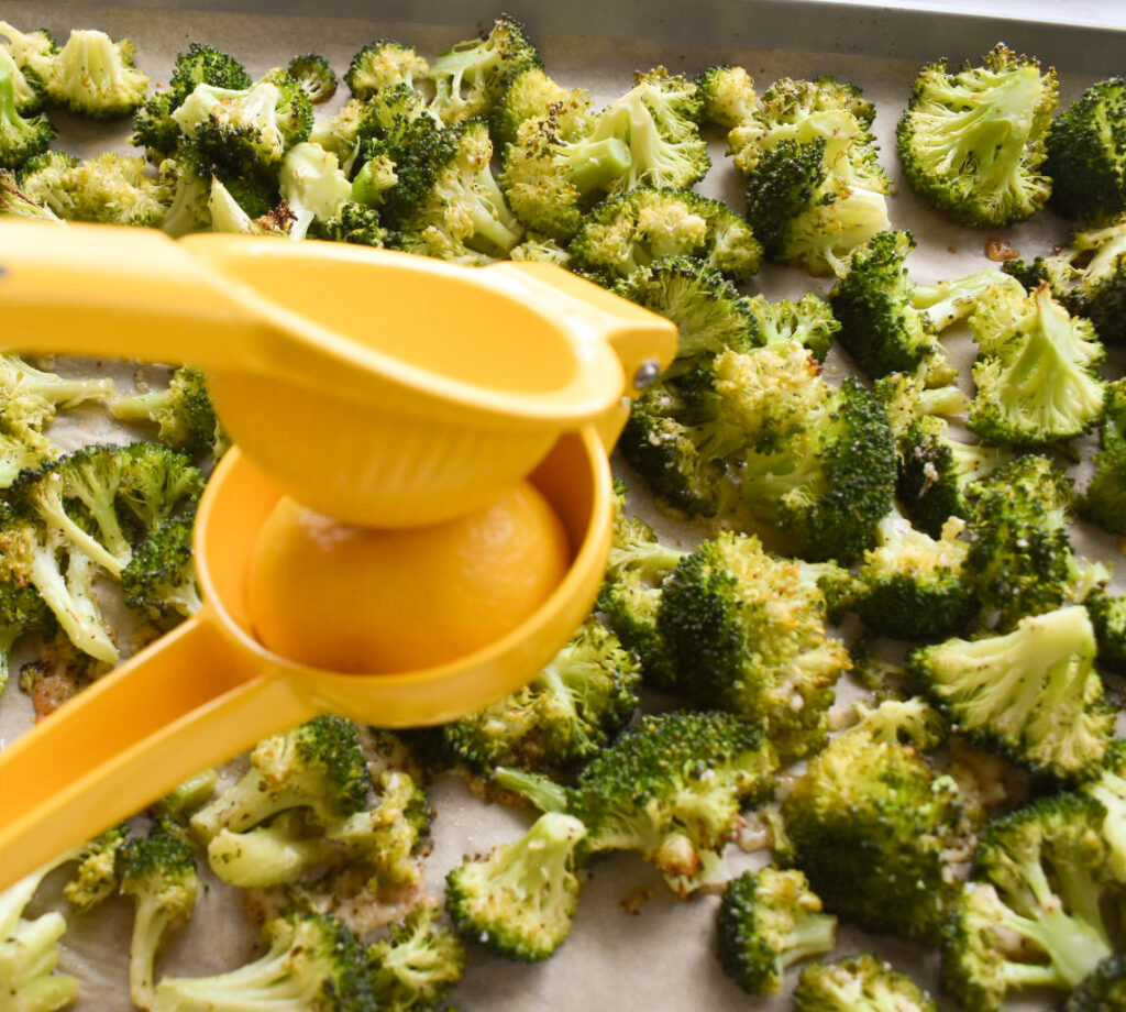 Crispy lemon parmesan roasted broccoli on a baking sheet