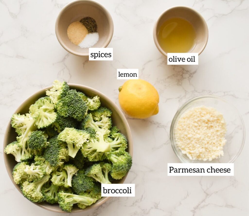 Ingredients in roasted broccoli with golden edges and melted parmesan
