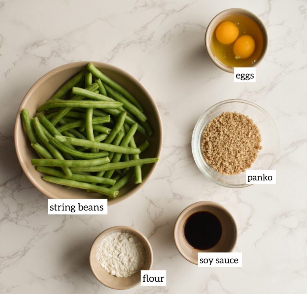 ingredients in Fresh string beans tossed with olive oil and flour before air frying.