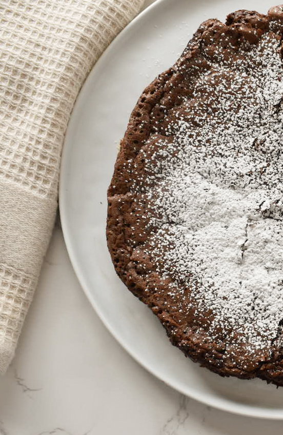 Chocolate cake slice served with fresh berries