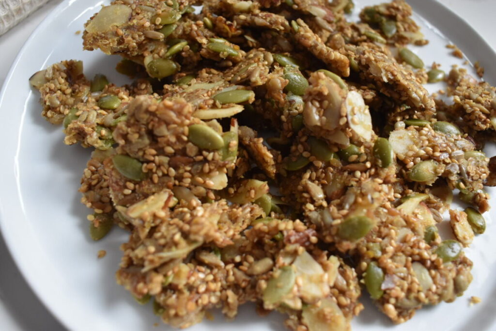 Homemade seed and almond crackers on parchment paper