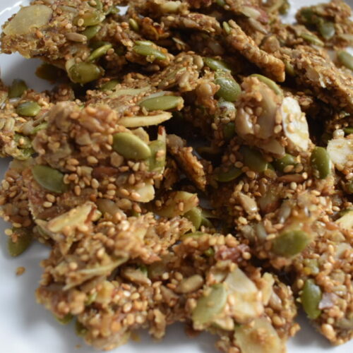 Homemade seed and almond crackers on parchment paper