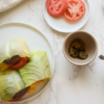 Cabbage wrapped burger with melted cheddar and fresh toppings