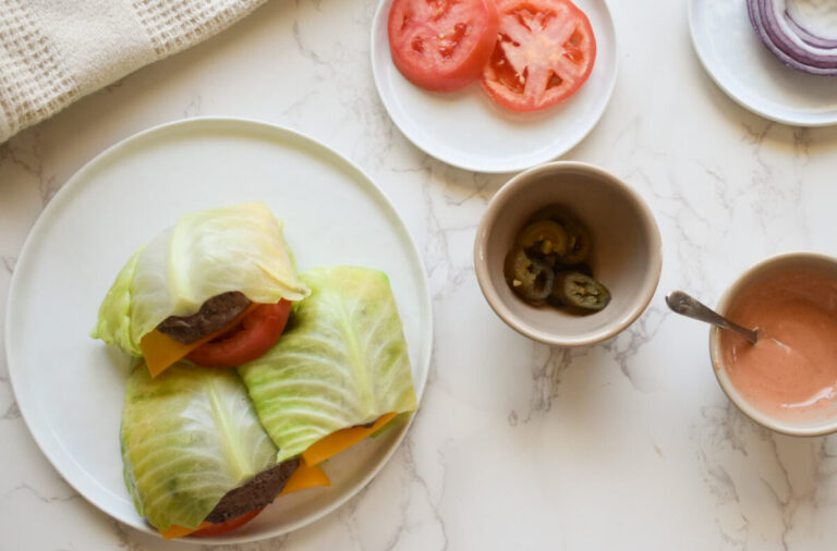 Cabbage wrapped burger with melted cheddar and fresh toppings