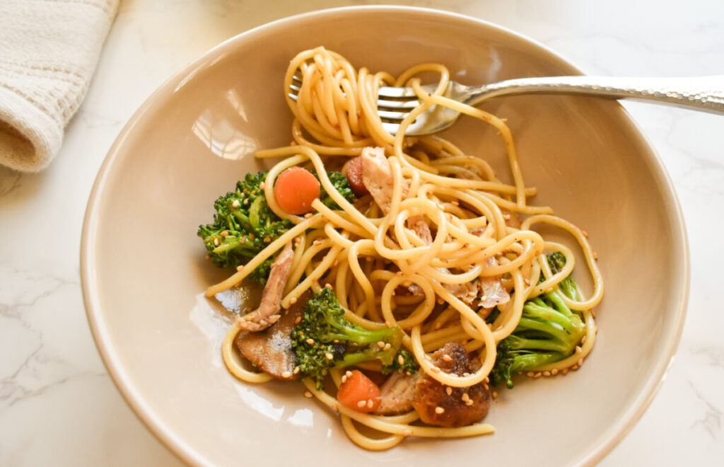 Easy sesame ginger chicken pasta dinner in cast iron pan