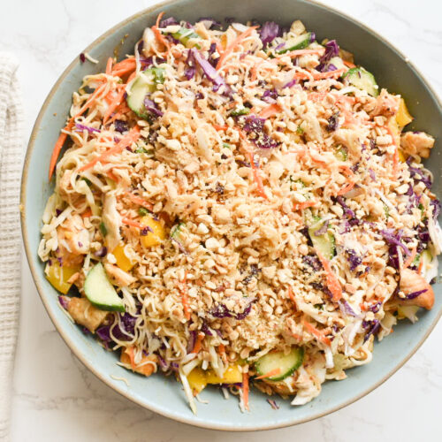 Colorful cabbage ramen salad with sliced chicken and crushed peanuts