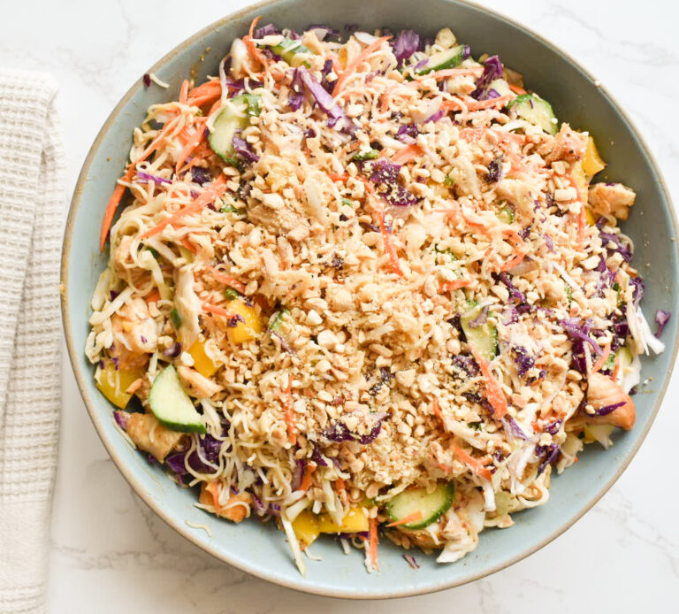 Colorful cabbage ramen salad with sliced chicken and crushed peanuts
