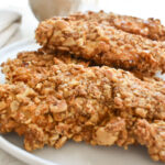 Close-up of crunchy pretzel crusted chicken sliced on plate