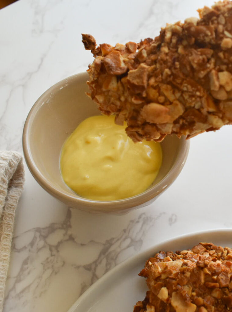 Dipping chicken into pretzel peanut coating step-by-step