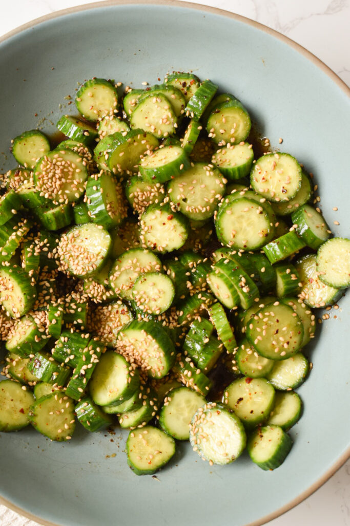 Sesame Ginger Baby Cucumber Salad served in a bowl with sesame seeds and scallions