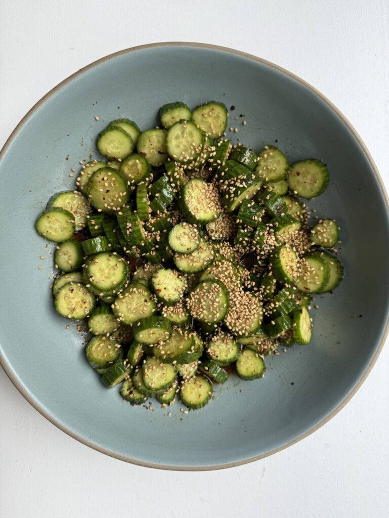 Sweet and spicy cucumber salad topped with crushed peanuts and scallions
