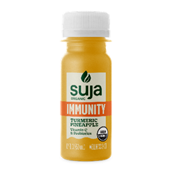 Cold pressed juices with turmeric and ginger on a kitchen counter