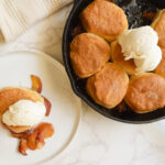 Cast iron peach cobbler with golden biscuit topping