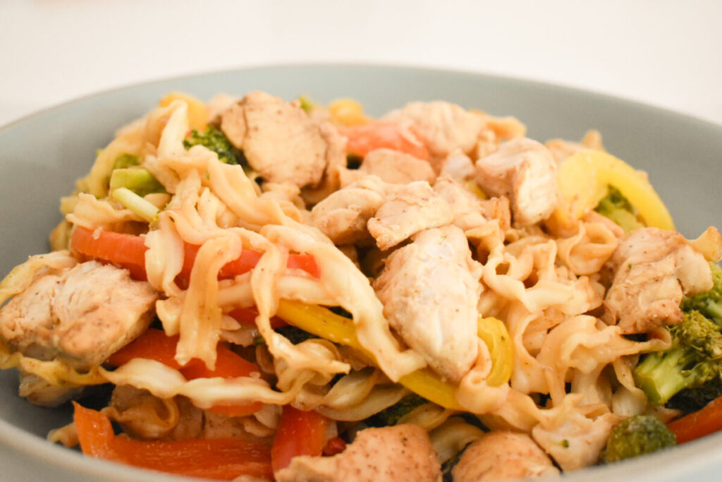 Close-up of chicken and veggie ramen tossed together