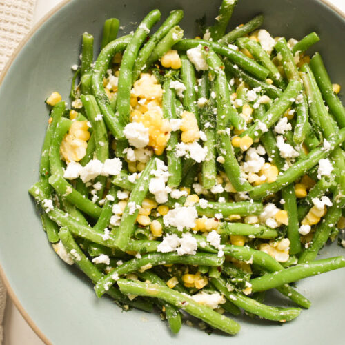 Fresh green bean salad with sweet corn, feta cheese, and lemon dressing
