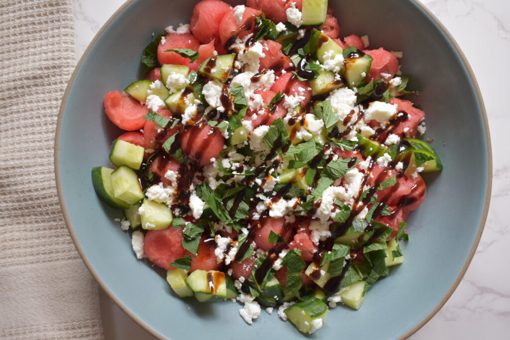 Close-up of watermelon cucumber feta salad with fresh mint