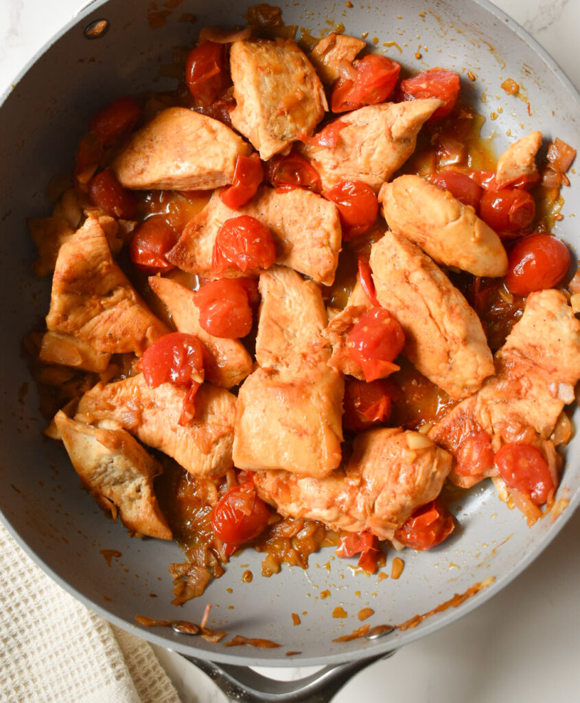 Sweet and tangy tomato chicken served in a skillet