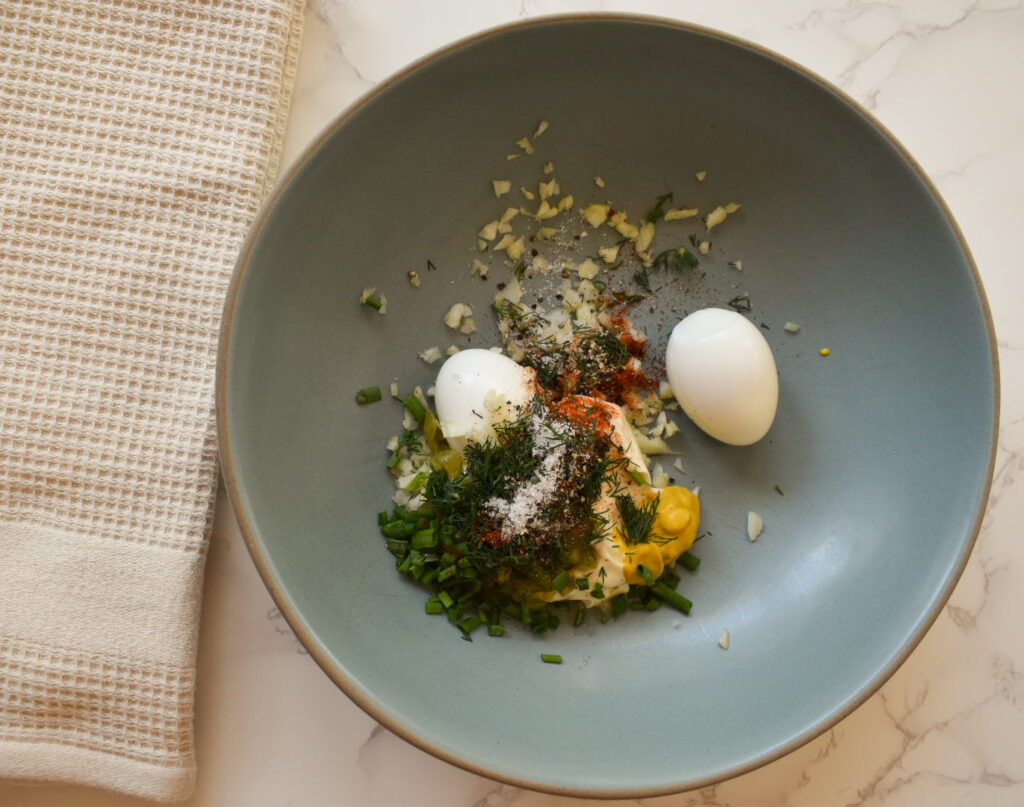 Creamy baby potato salad garnished with fresh dill and chives