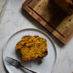 Moist pumpkin chocolate chip bread baked in a 9×5-inch loaf pan with chocolate chips on top.