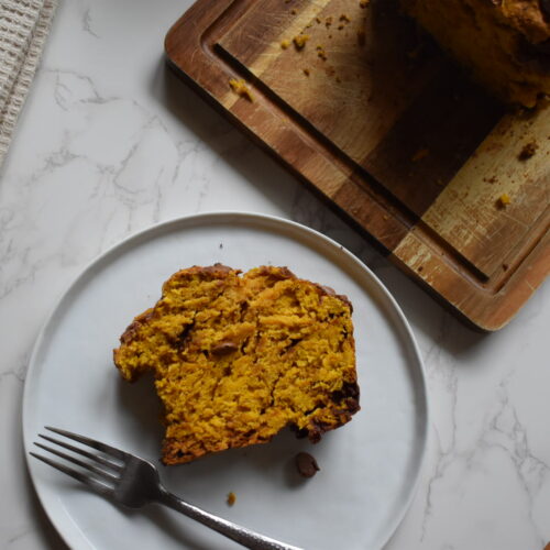 Moist pumpkin chocolate chip bread baked in a 9×5-inch loaf pan with chocolate chips on top.