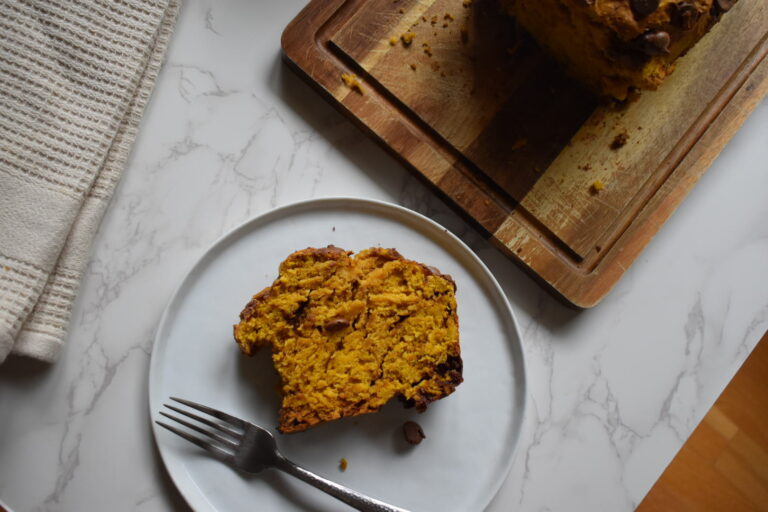Moist pumpkin chocolate chip bread baked in a 9×5-inch loaf pan with chocolate chips on top.