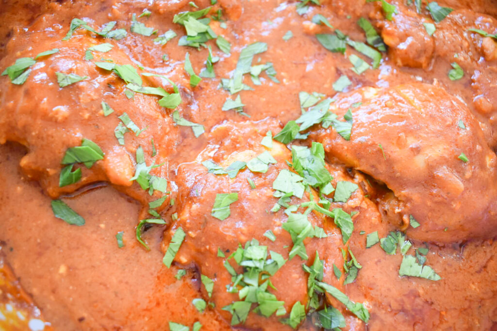 Homemade coconut chicken curry served over basmati rice with fresh cilantro.
