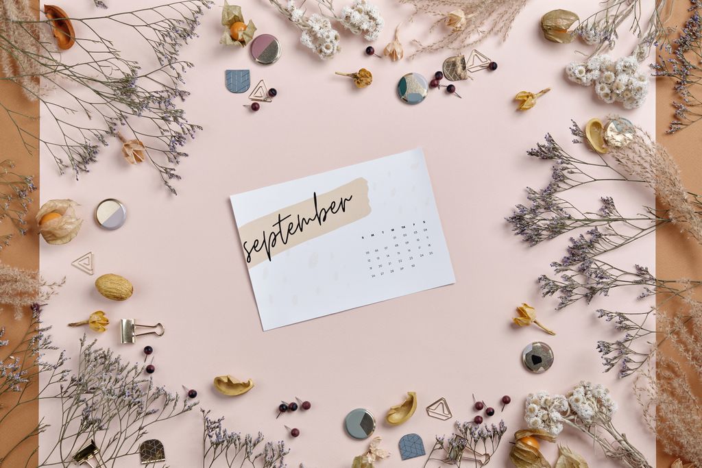 An elegant September calendar surrounded by dried flowers and decorative elements, offering ample copy space.